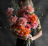 Byron Bay Florist - Lady holding orange and pink roses